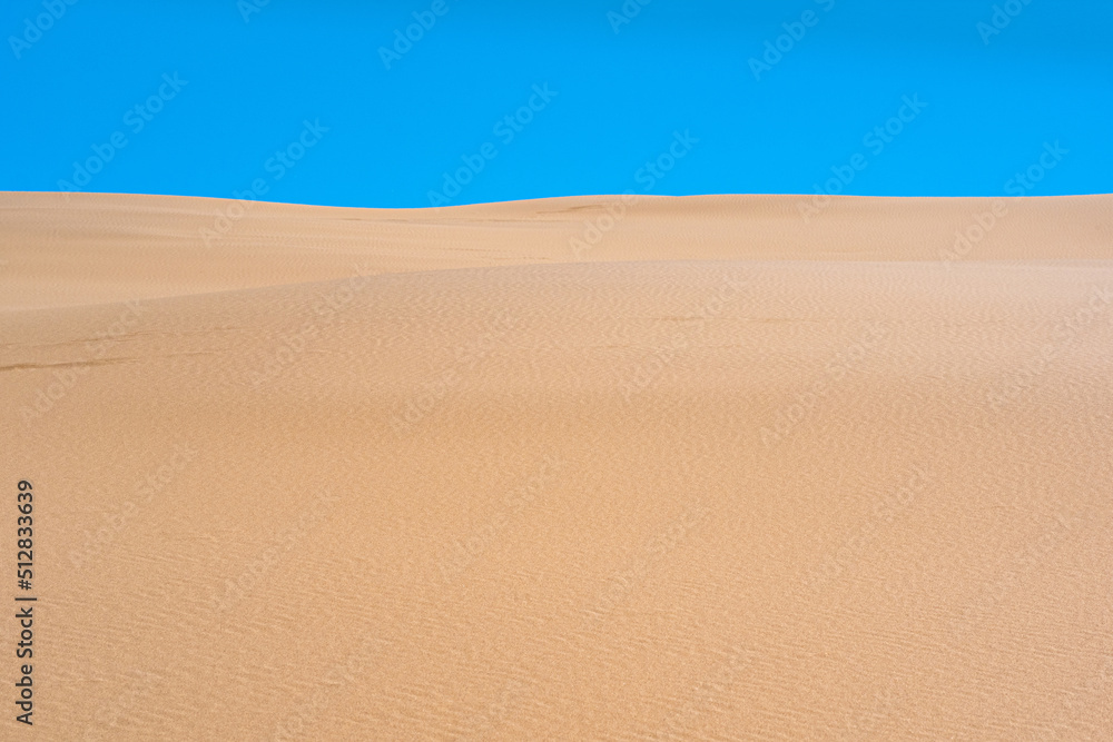 lifeless sandy desert landscape under blue sky lifeless sandy desert landscape under blue sky