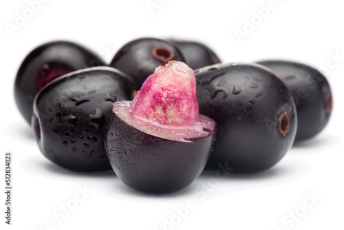 Close-Up of collection of Indian Ayurvedic medicinal fresh organic fruit jamun (Syzygium Cumini) or black plum, with peeled seed , half cut fruit,  isolated in white background. photo