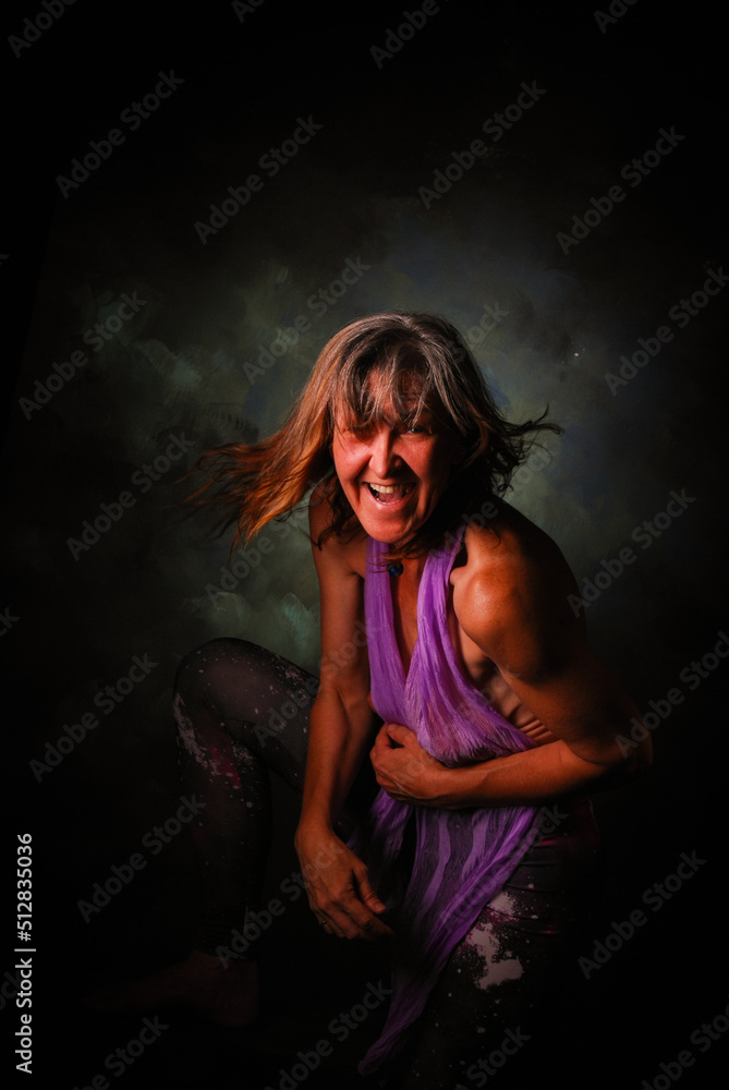 moody portrait of wild woman in laughter