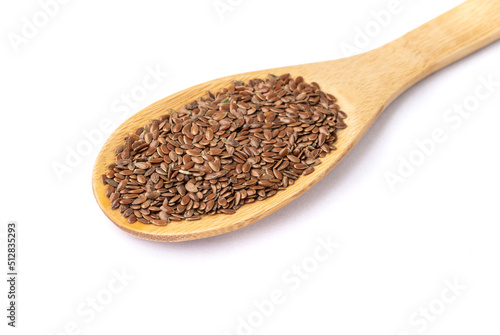 Brown linseed on a spoon isolated over white background