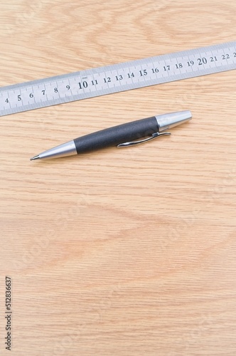 pencil and metal ruler on a wooden desk with copy space © divgradcurl