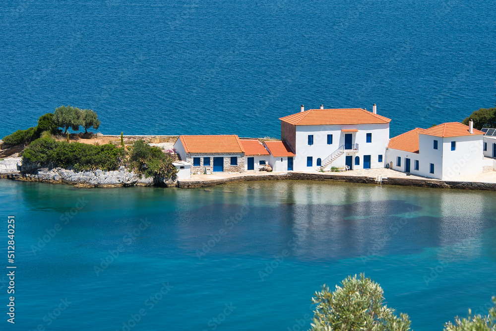 Wonderful Greek landscape, traditional house in front of a small bay and an olive grove that touches the sea. Pelion, Trikeri, Greece