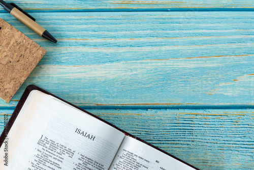 Εκτύπωση καμβά Isaiah open Holy Bible Book on a rustic wooden background with a notebook and pen