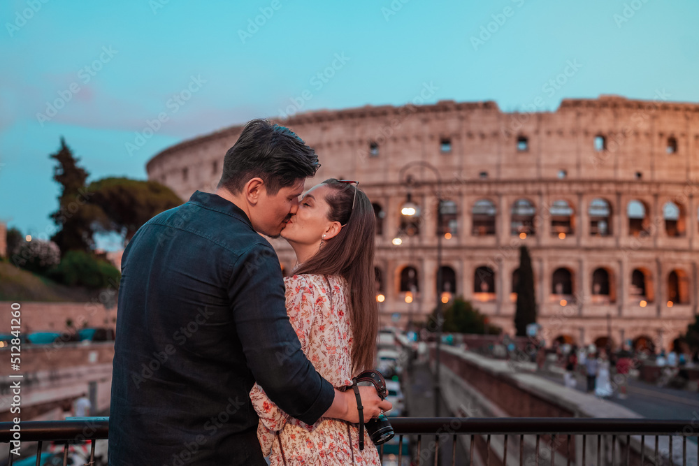 portrait of a couple in love in front of the roman colosseum