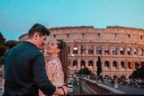 portrait of a couple in love in front of the roman colosseum