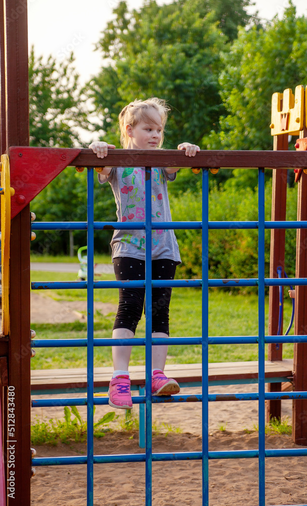 Obraz premium A young girl in the park on the playground