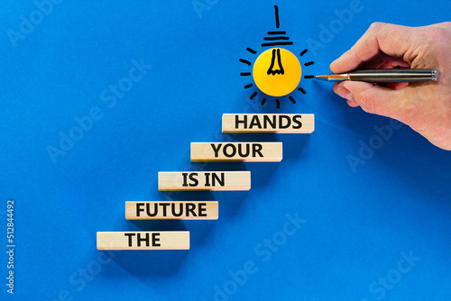 The future is in your hands symbol. Concept words The future is in your hands on wooden blocks on a beautiful blue table blue background. Businessman hand. Business and future in your hands concept.