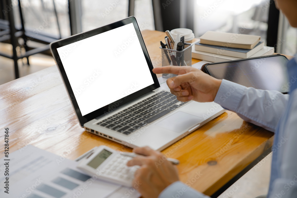 Close up of businessperson using laptop working with digital data.
