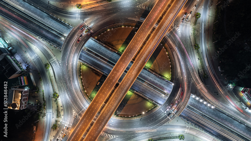 Φωτογραφία Aerial top view road roundabout interchange in city at night, Aerial view of highway and overpass in city at night