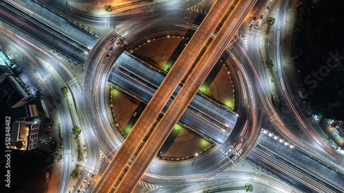 Aerial top view road roundabout interchange in city at night, Aerial view of highway and overpass in city at night.