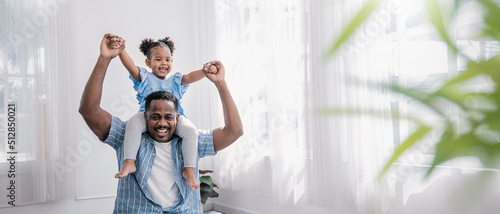 Obraz na płótnie Happy black African American father daughter playing at home living room