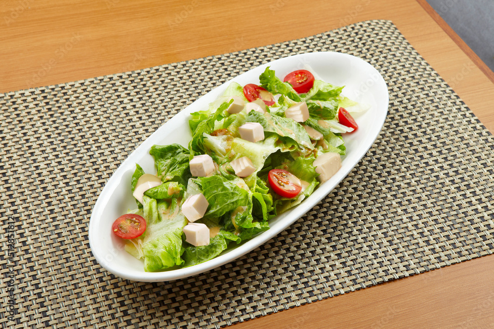 Tofu Salad served in a dish isolated on wooden table background side view of singapore food Tofu Salad served in a dish isolated on wooden table background side view of singapore food