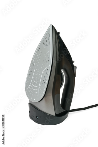Black electric iron with grey sole insulated on white background.
