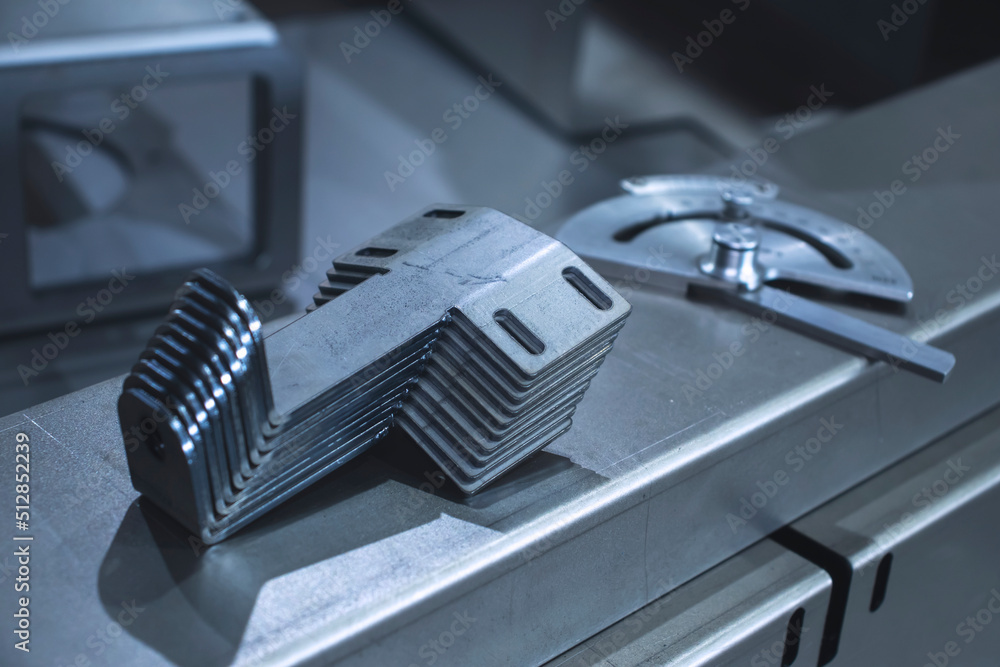 Sheet steel metal products bent on a CNC bending machine, metalworking close-up in a factory Sheet steel metal products bent on a CNC bending machine, metalworking close-up in a factory