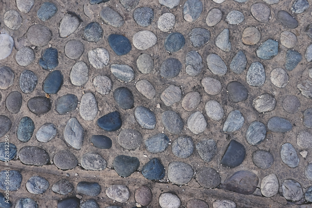 The wall is made of river stones. Background from natural stones The wall is made of river stones. Background from natural stones