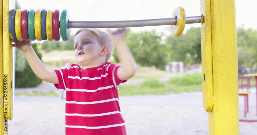 Happy smiling boy having fun on the playground. Kids leisure activity Happy smiling boy having fun on the playground. Kids leisure activity