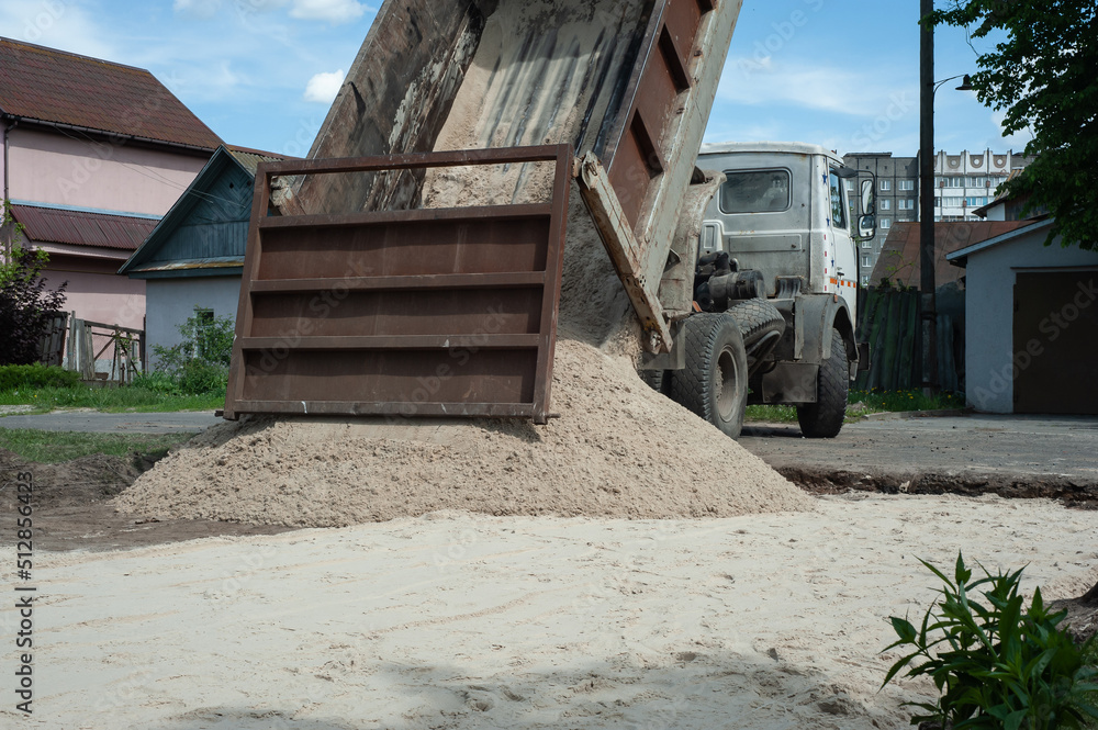 Dump trucks carrying good filling a field, giving rise to a fine soil. Preparation and construction. Dump trucks carrying good filling a field, giving rise to a fine soil. Preparation and construction.