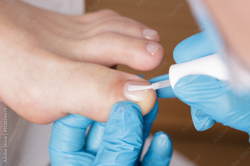 pedicure master applies colorless nail polish pedicure master applies colorless nail polish