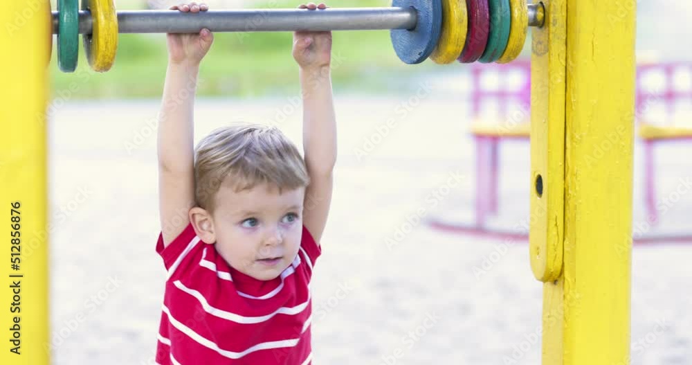 Happy smiling boy having fun on the playground. Kids leisure activity Happy smiling boy having fun on the playground. Kids leisure activity