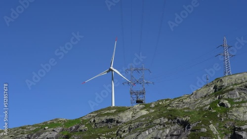 San Gottardo Mountain Pass, Switzerland. A wind turbine working at high mountain. The generator and base of the wind turbines. Renewable energy. Electrical windmills. General contest of green energy photo