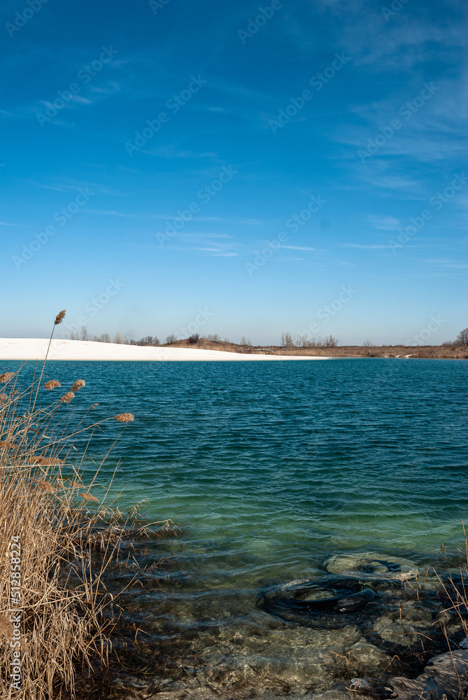 Lake and beautiful sky , blue colors of the sky and water , water reflactions . 
