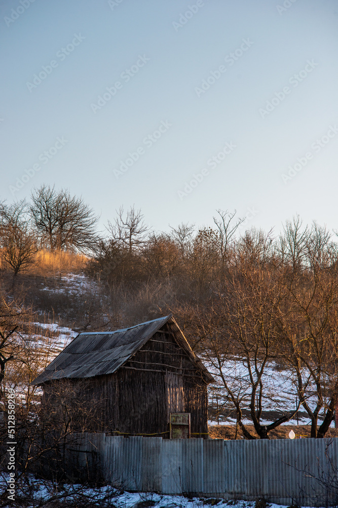 Old barn in winter , winter landscapes , winter sunny morning .Landscape with barn , sky and clouds , barn in the forest Old barn in winter , winter landscapes , winter sunny morning .Landscape with barn , sky and clouds , barn in the forest