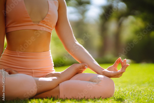 Young woman doing excercise at the public park. Fitness woman doing yoga exercises in the morning. Sport, Active life.