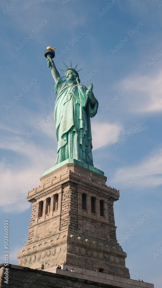 Fototapeta premium Statue of Liberty with Blue Sky few Clouds in Daylight