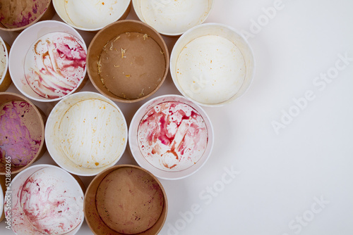 Dirty used disposable bowls on a light background.