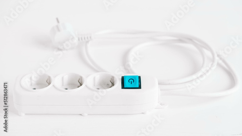 Modern white electric extension cord with a button on a white background