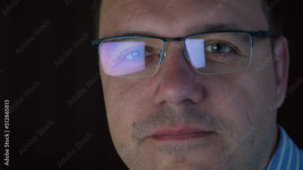 Close up portrait of confident smiling trader man in glasses looking at camera at late time in office Close up portrait of confident smiling trader man in glasses looking at camera at late time in office