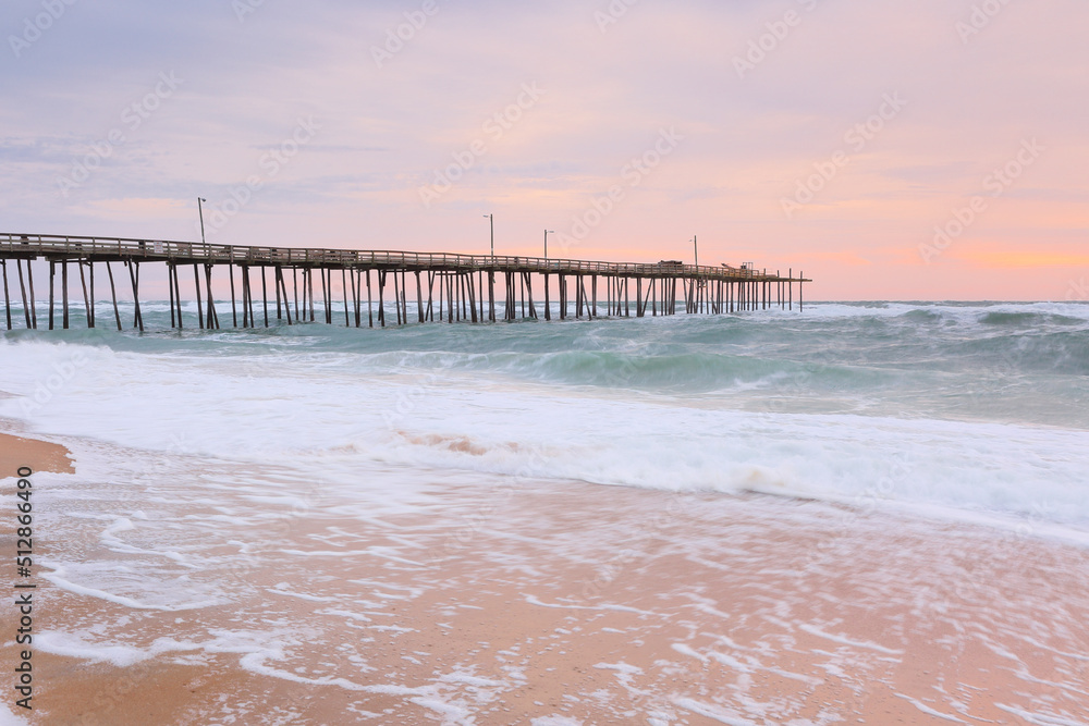 Beautiful sunrise at Nags Head Pier, Outer Banks, North Carolina, USA.  Nags Head is one of the most popular beach of the outer Banks for its  wealth of amenities, sprawling ocean and soundfront view