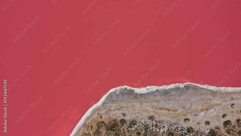 Flying over a pink salt lake. Salt production facilities saline
