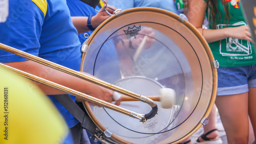 Manos de musico tocando el tambor o el bombo en banda en fiestas locales photo