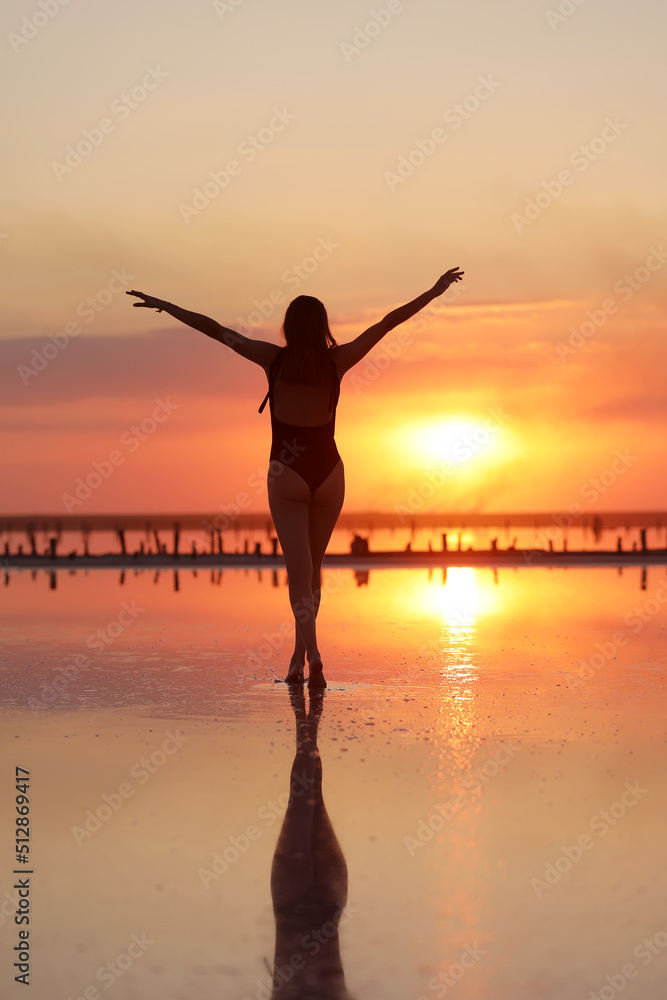 young slim beautiful woman on sunset beach, playful, dancing, running, bohemian outfit, indie style, summer vacation, sunny, having fun, positive mood, romantic, splashing water, silhouette, happy.