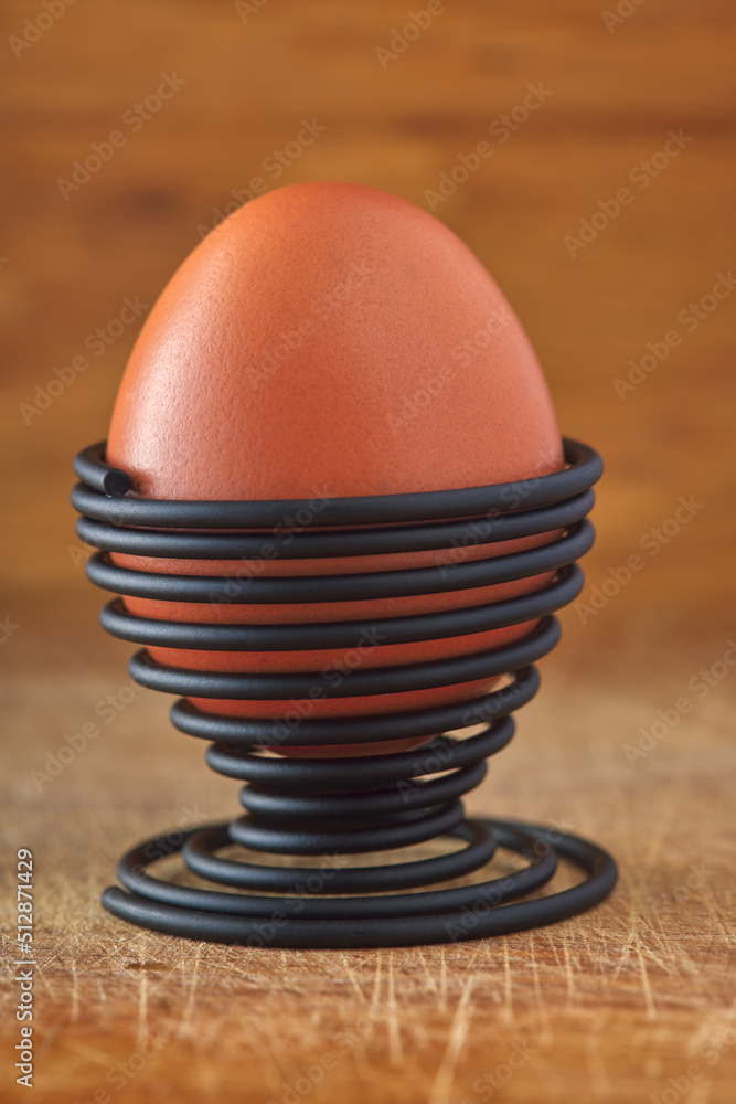 One boiled egg in a spiral-shaped metal support One boiled egg in a spiral-shaped metal support