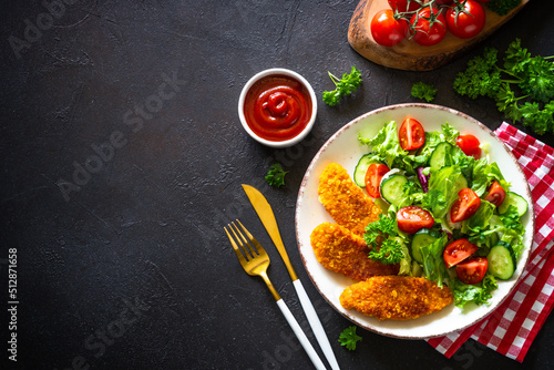 Chicken nuggets with fresh salad.