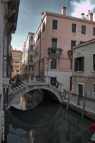 Scenic arc bridge over small canal in residential neighborhood in Venice, Italy