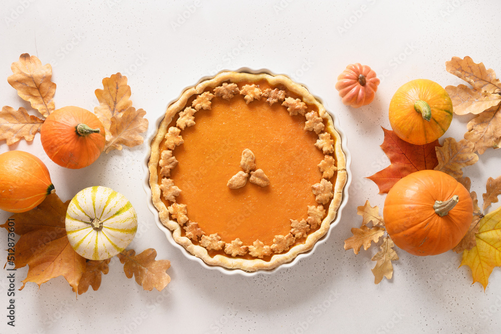 Fototapeta premium Thanksgiving Day American Pumpkin Pie with squash on white background. View from above. Flat lay. Banner.