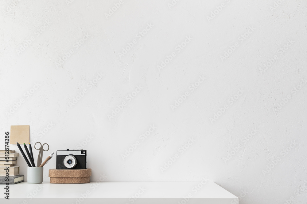Office table, empty desk with supplies and white wall copy space. Creative workspace. Office table, empty desk with supplies and white wall copy space. Creative workspace.