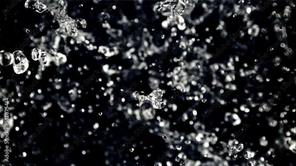 The movement of a drop of water in flight. Top view. On a black background. Filmed on a high-speed camera at 1000 fps. The movement of a drop of water in flight. Top view. On a black background. Filmed on a high-speed camera at 1000 fps.