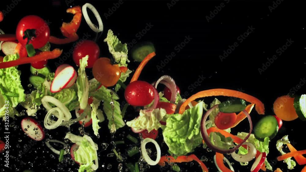 Sliced lettuce, onions, peppers and tomatoes soar up and fall. On a black background. Filmed on a high-speed camera at 1000 fps. Sliced lettuce, onions, peppers and tomatoes soar up and fall. On a black background. Filmed on a high-speed camera at 1000 fps.