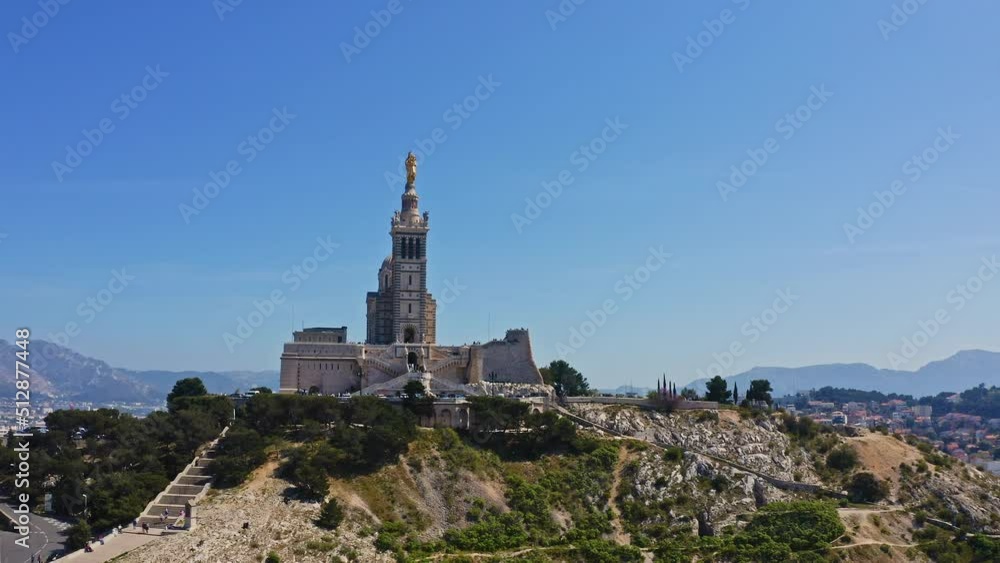 Aerial view shot from flying drone of Marseille french city picturesque hilltop island medieval basilica Notre-Dame de la Garde historic temple catholic church with gilded Madonna sculpture on mount Aerial view shot from flying drone of Marseille french city picturesque hilltop island medieval basilica Notre-Dame de la Garde historic temple catholic church with gilded Madonna sculpture on mount