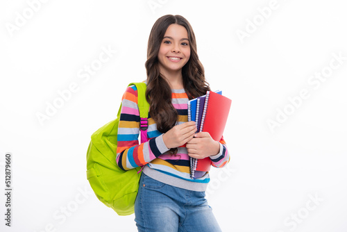 Schoolchild, teenage student girl with school bag backpack hold book on white isolated studio background. Children school and education concept. Happy girl face, positive and smiling emotions.