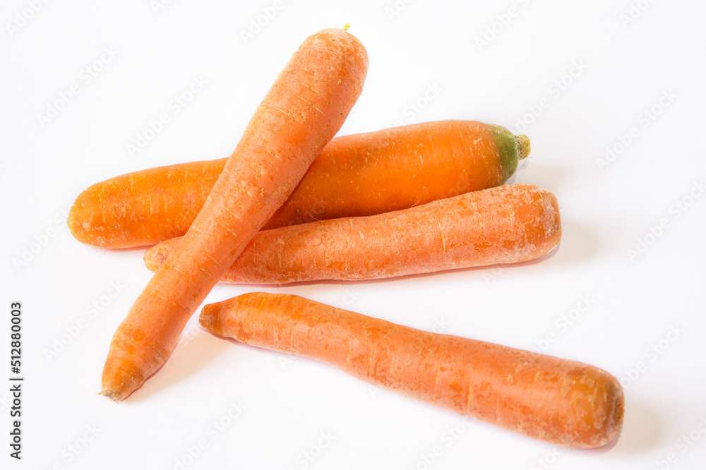 several carrots are lying on a white background several carrots are lying on a white background