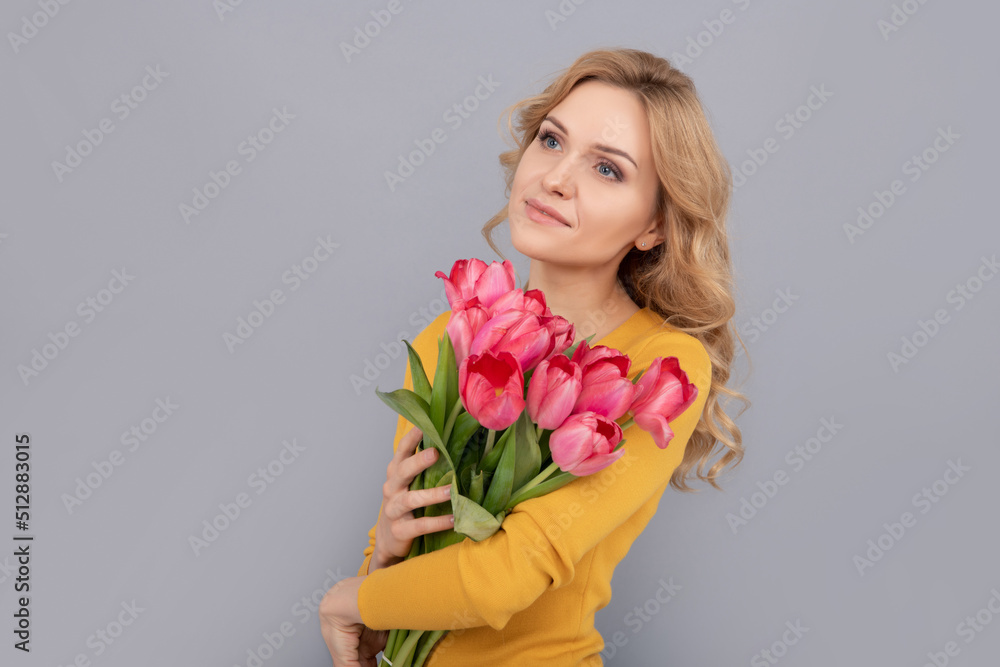 woman with floral present for womens day on grey background woman with floral present for womens day on grey background