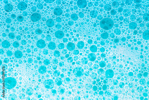 foam bubbles.Blue water with white foam bubbles.Cleanliness and hygiene background. Foam Water Soap Suds.Texture Foam Close-up. blue soap bubbles background. 