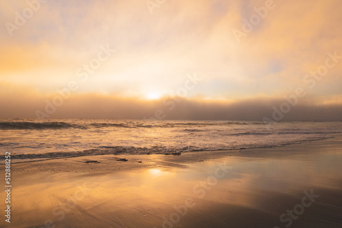 Dramatic sunset on the beach with marine layer clouds moving in from the ocean