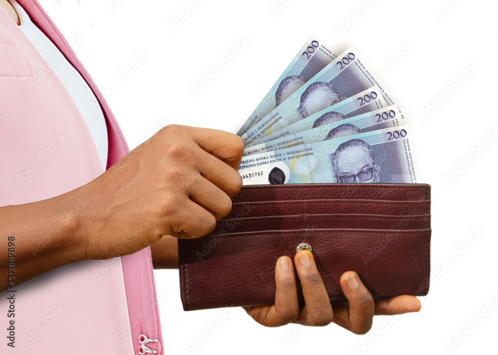 fair Female Hand Holding brown Purse With 200 Bosnia and Herzegovina convertible mark notes, hand removing money out of purse isolated on white. removing money from wallet - obrazy, fototapety, plakaty 