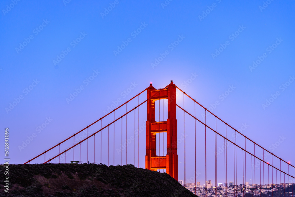 Fototapeta premium Full Moon June 2022 San Francisco Golden Gate Bridge Through North Tower Shot From Marin Headlands